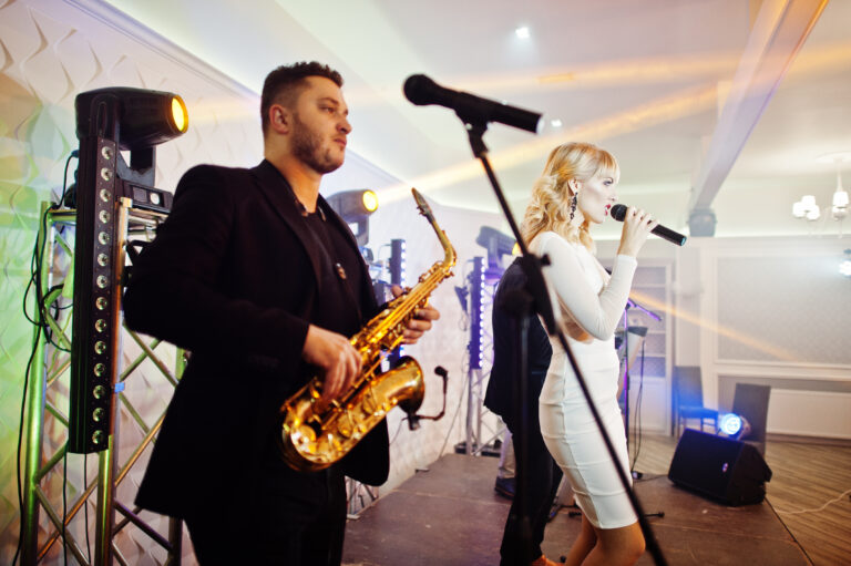 Musicial music live band performing on a stage with different li